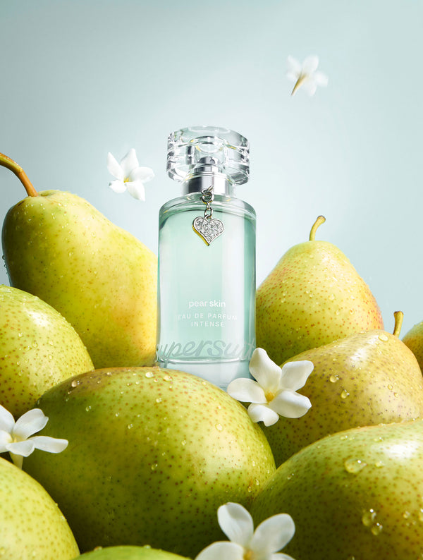 Pear Skin Eau De Parfum Intense 1.7 fl oz bottle with pears and jasmine flowers on a light background